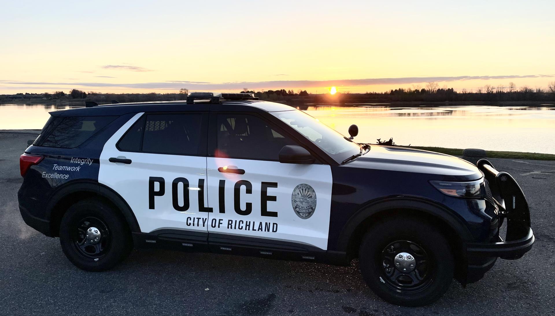 Richland Police car in front of river at sunrise