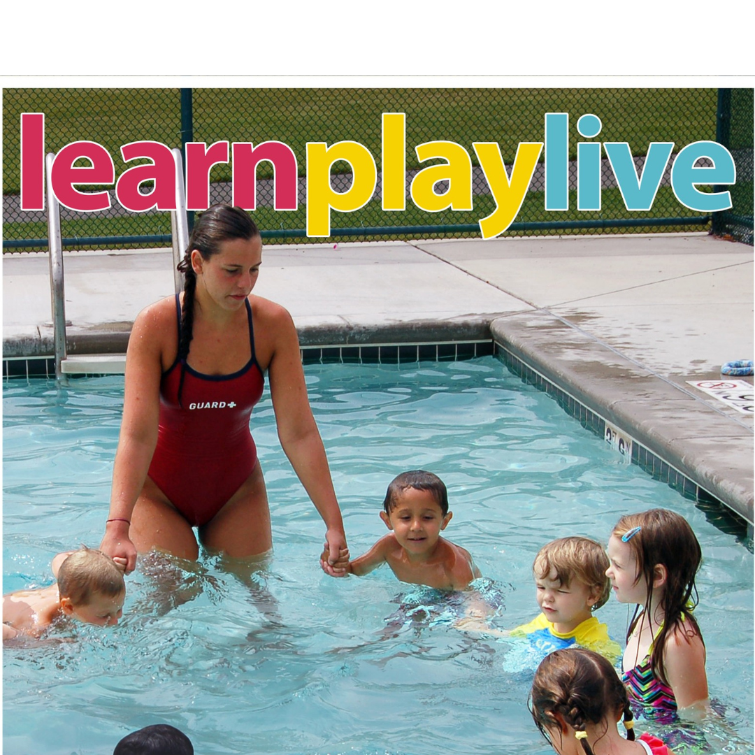 a lifeguard teaching children in a swimming pool and holding hands